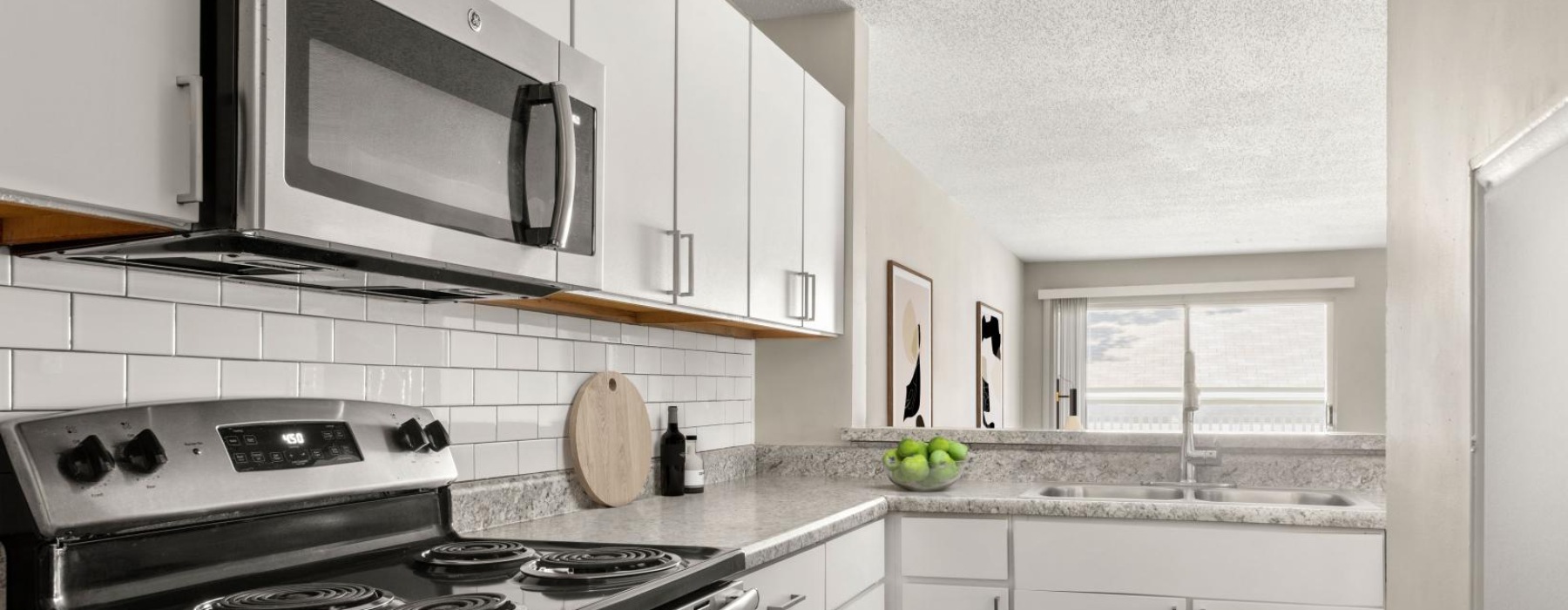 a kitchen with white cabinets