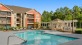 a swimming pool in front of a large building