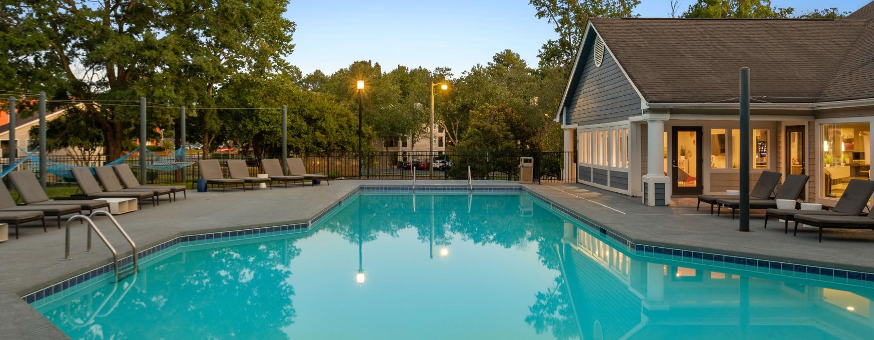 a swimming pool with a house in the background